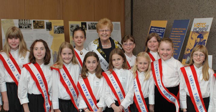 Hon. Barbara Roberts with student singers from Glencoe Elementary School who gave a rousing rendition of a pro-suffrage song.